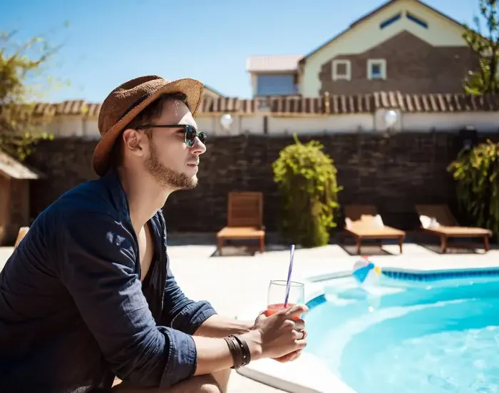 man sunglasses hat drinking cocktail sitting near pool 176420 3986