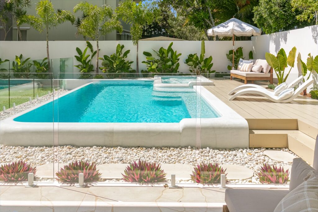 Contemporary Concrete Pool Design - A contemporary concrete pool showcasing the seamless integration of water and landscape, ideal for a sophisticated outdoor retreat.